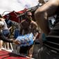 Volunteers load supplies onto a boat for West Maui at the Kihei boat landing, after a wildfire destroyed much of the historical town of Lahaina, on the island of Maui, Hawaii Sunday, Aug. 13, 2023. (Stephen Lam/San Francisco Chronicle via AP)