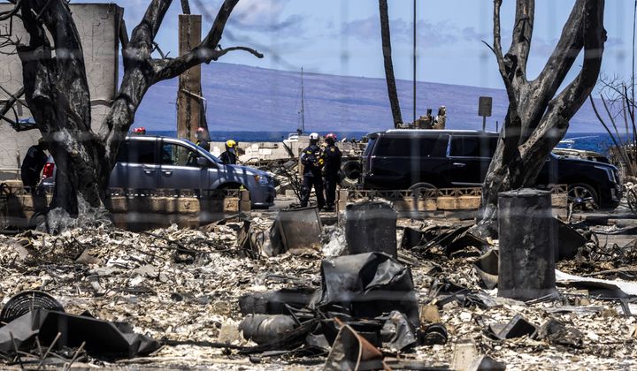 Members of an Urban Search and Rescue Task Force are seen along Front Street destroyed by the West Maui Fire, in Lahaina on the island of Maui, Hawaii Thursday, Aug. 17, 2023. Authorities are continuing the search and recovery efforts a week after multiple wind-driven wildfires devastated the island, with at least 111 deaths and many still missing. (Stephen Lam/San Francisco Chronicle via AP)